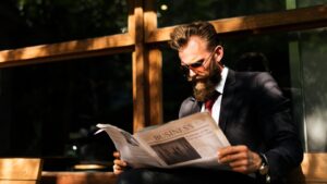 Businessman reading newspaper at coffee shop